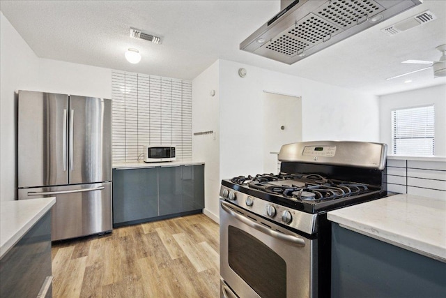300 Tilbury Ln, Austin, TX 78745 - kitchen with stainless steel appliances, gray cabinets, light wood-style floors, custom range hood, and ceiling fan