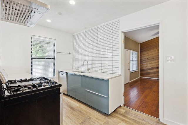 300 Tilbury Ln, Austin, TX 78745 - kitchen featuring black gas range, gray cabinetry, dishwasher, light wood finished floors, and healthy amount of natural light