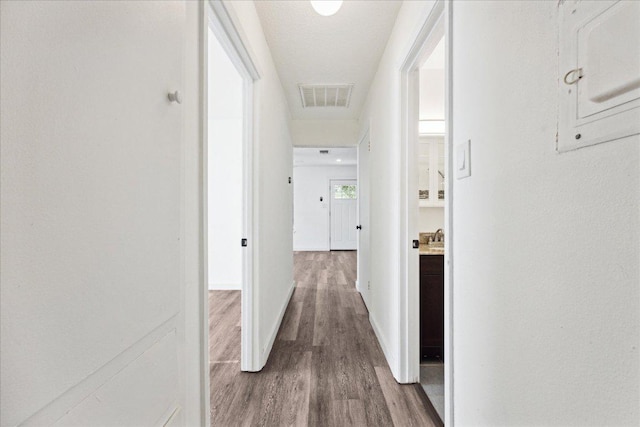 300 Tilbury Ln, Austin, TX 78745 - hall featuring dark wood finished floors and baseboards