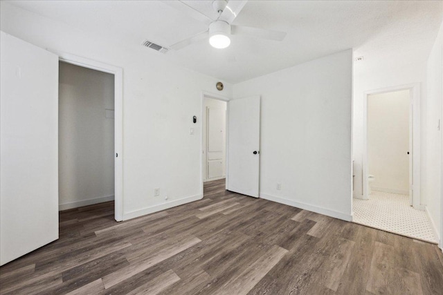 300 Tilbury Ln, Austin, TX 78745 - unfurnished bedroom with wood finished floors, a closet, ensuite bathroom, and a ceiling fan