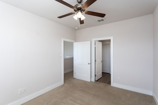 unfurnished bedroom with ceiling fan, carpet flooring, and a walk in closet