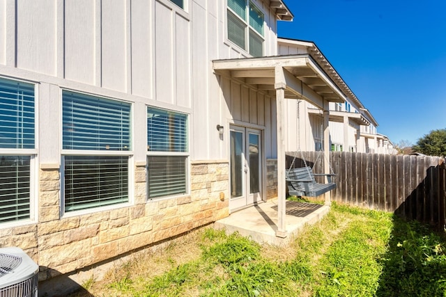 property entrance featuring central AC unit