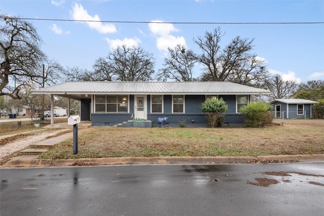 view of front facade featuring a front lawn and a carport