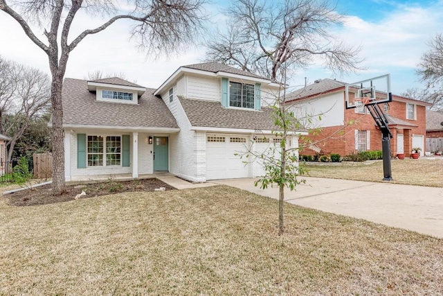 view of property featuring a front yard and a garage