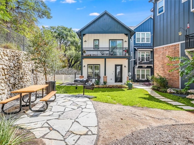 3809 Valley View Rd Unit 1, Austin, TX 78704 - back of property with board and batten siding, a balcony, brick siding, and a patio area