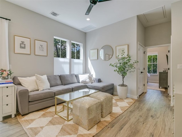 living room with light hardwood / wood-style flooring and ceiling fan