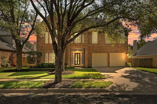 view of front of property with a garage and a yard