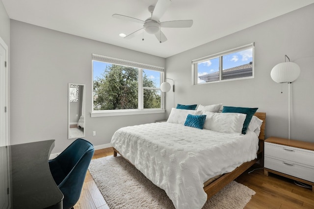 bedroom with ceiling fan and wood-type flooring