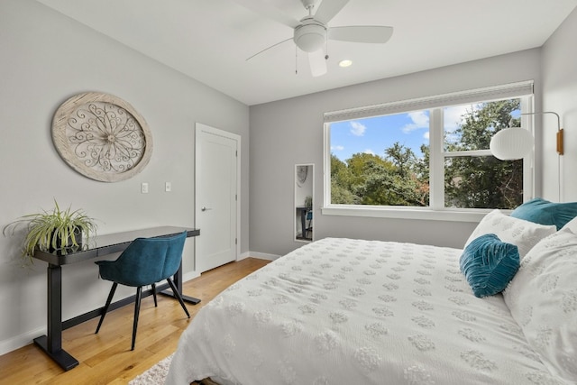 bedroom featuring hardwood / wood-style flooring and ceiling fan