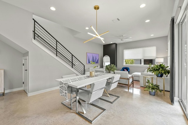 dining room featuring ceiling fan with notable chandelier