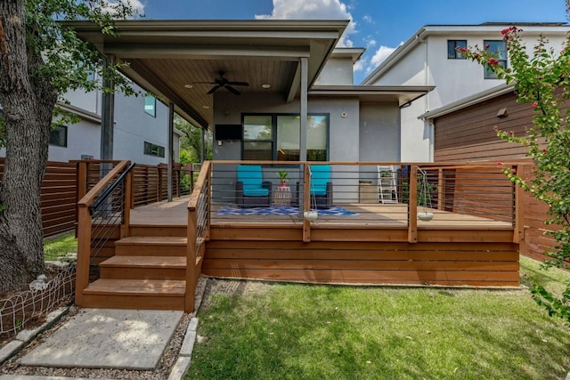 back of property featuring a yard, ceiling fan, and a wooden deck