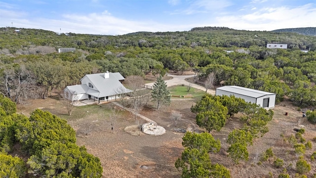 birds eye view of property featuring a wooded view
