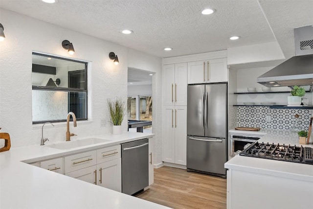 200 Shady River Rd, Wimberley, TX 78676 - kitchen with appliances with stainless steel finishes, open shelves, a sink, wall chimney range hood, and white cabinetry