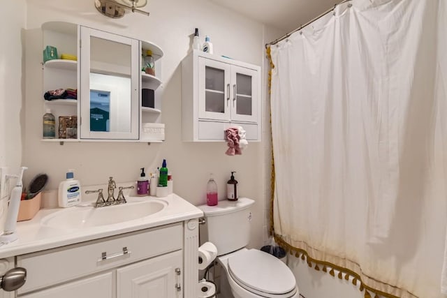 bathroom featuring vanity, a shower with curtain, and toilet