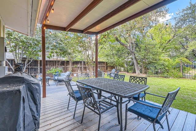 deck featuring a yard and grilling area