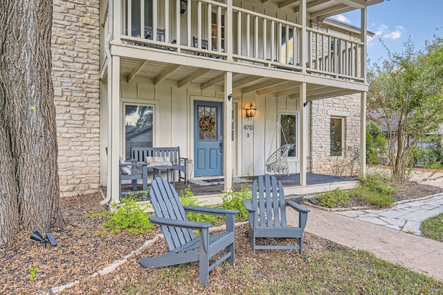 view of exterior entry featuring a balcony