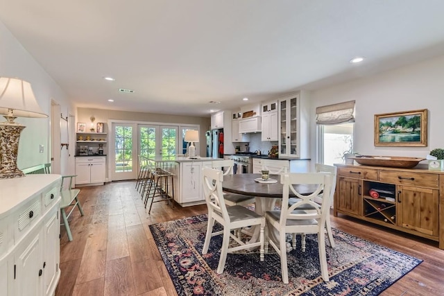 dining room with hardwood / wood-style flooring and plenty of natural light