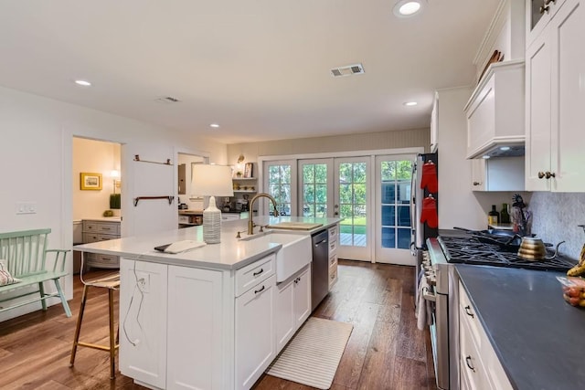 kitchen featuring white cabinets, an island with sink, french doors, and stainless steel appliances