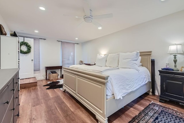 bedroom with ceiling fan and dark wood-type flooring