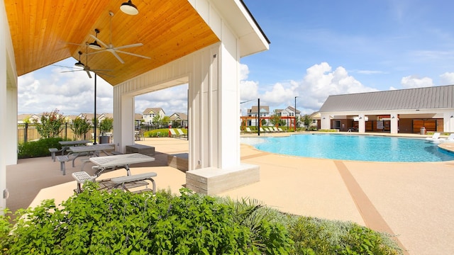 view of swimming pool with a patio and ceiling fan