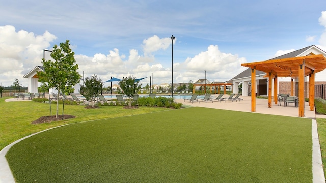 view of yard with a water view, a community pool, and a pergola