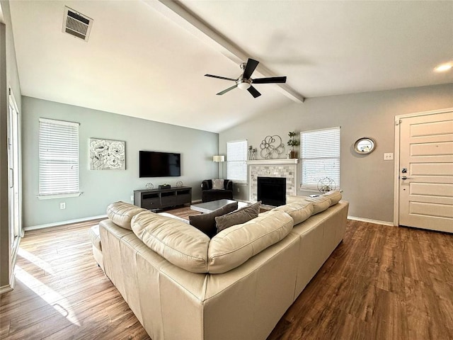 living room with wood-type flooring, ceiling fan, and vaulted ceiling with beams