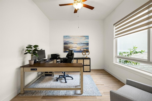 home office featuring baseboards, wood finished floors, and ceiling fan