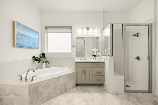 full bathroom featuring vanity, a shower stall, a bath, and tile patterned flooring
