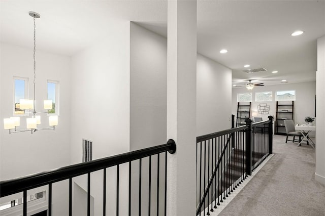 hall with carpet flooring, an upstairs landing, a chandelier, visible vents, and recessed lighting