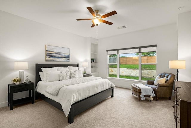 bedroom with light colored carpet, visible vents, and a ceiling fan
