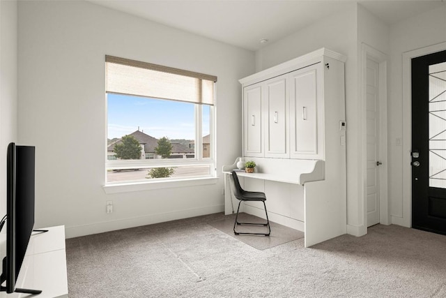 office area with light colored carpet and baseboards
