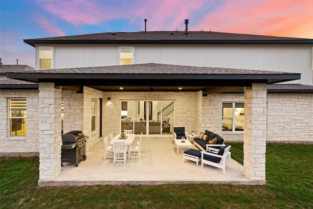 rear view of property with a shingled roof, stucco siding, and a patio area