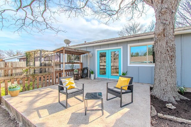 view of patio / terrace featuring fence and french doors