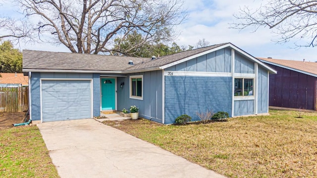 view of front of property featuring an attached garage, fence, concrete driveway, board and batten siding, and a front yard