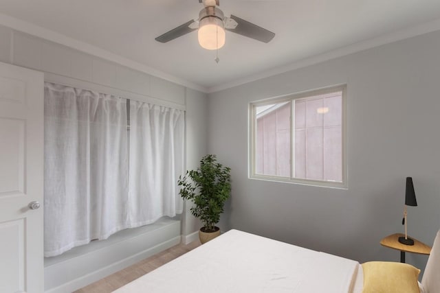 bedroom with crown molding, baseboards, and ceiling fan