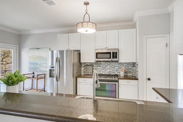 kitchen featuring appliances with stainless steel finishes, tasteful backsplash, crown molding, decorative light fixtures, and white cabinets