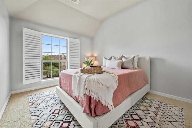 bedroom featuring vaulted ceiling, baseboards, light colored carpet, and visible vents