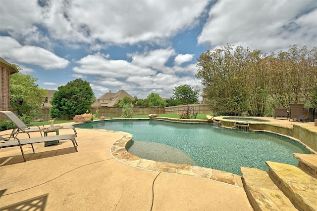 view of pool featuring a fenced backyard, a patio area, and a pool with connected hot tub