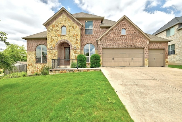 view of front of home featuring stone siding, brick siding, concrete driveway, a front yard, and a garage