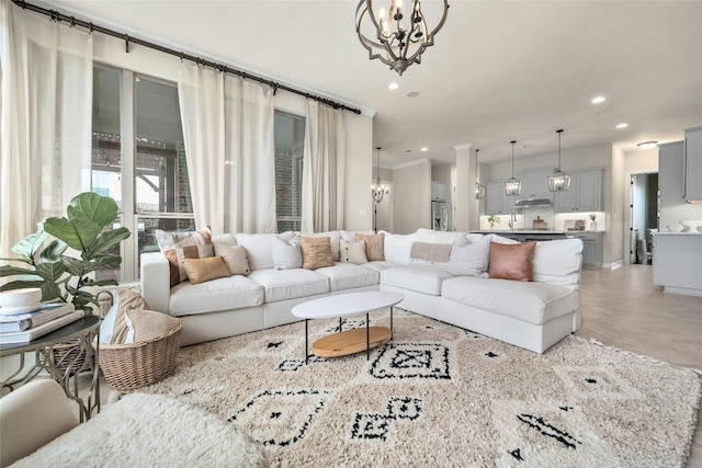 living area with an inviting chandelier and recessed lighting