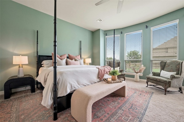 carpeted bedroom featuring baseboards, visible vents, and ceiling fan