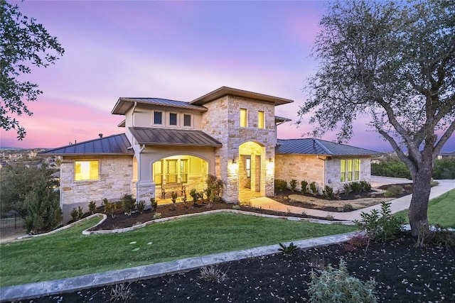 205 Palazza Alto Dr, Austin, TX 78734 - view of front of home featuring a standing seam roof, stone siding, a metal roof, and a lawn