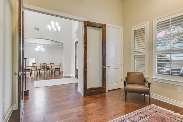 205 Palazza Alto Dr, Austin, TX 78734 - foyer entrance with a chandelier, wood finished floors, arched walkways, and plenty of natural light