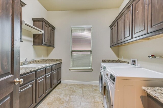 205 Palazza Alto Dr, Austin, TX 78734 - washroom featuring cabinet space, washer and clothes dryer, baseboards, and light tile patterned flooring
