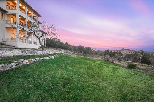 205 Palazza Alto Dr, Austin, TX 78734 - yard at dusk featuring a lawn and a balcony