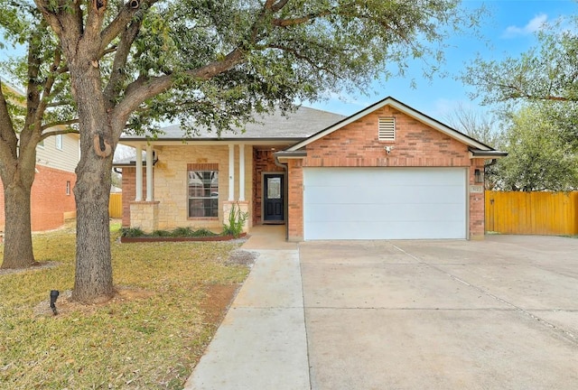 view of front of house featuring a garage, fence, concrete driveway, and brick siding