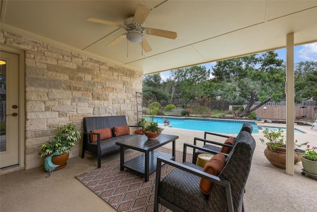 view of patio / terrace with outdoor lounge area, a fenced in pool, a ceiling fan, and a fenced backyard