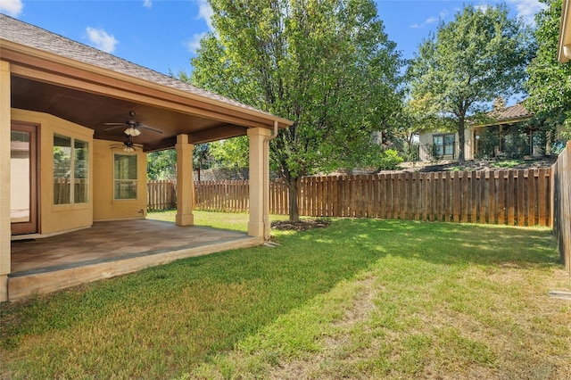 view of yard featuring fence private yard, a patio area, and ceiling fan