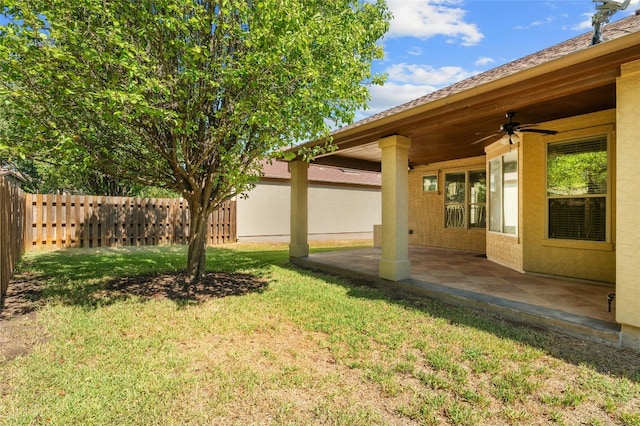 view of yard with a fenced backyard, a patio area, and ceiling fan