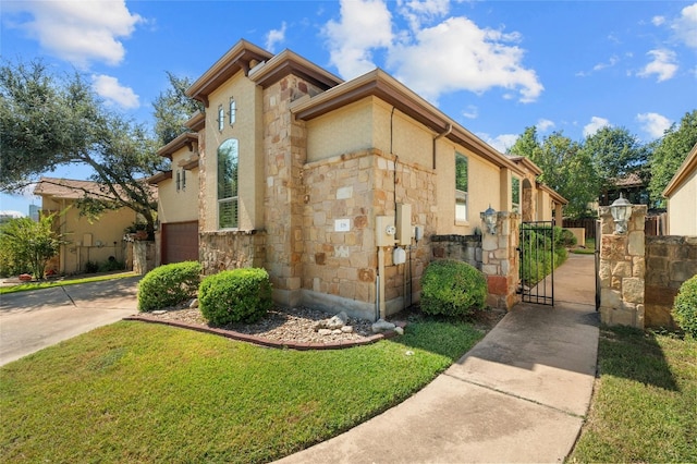 view of property exterior featuring stone siding, an attached garage, a gate, a yard, and concrete driveway